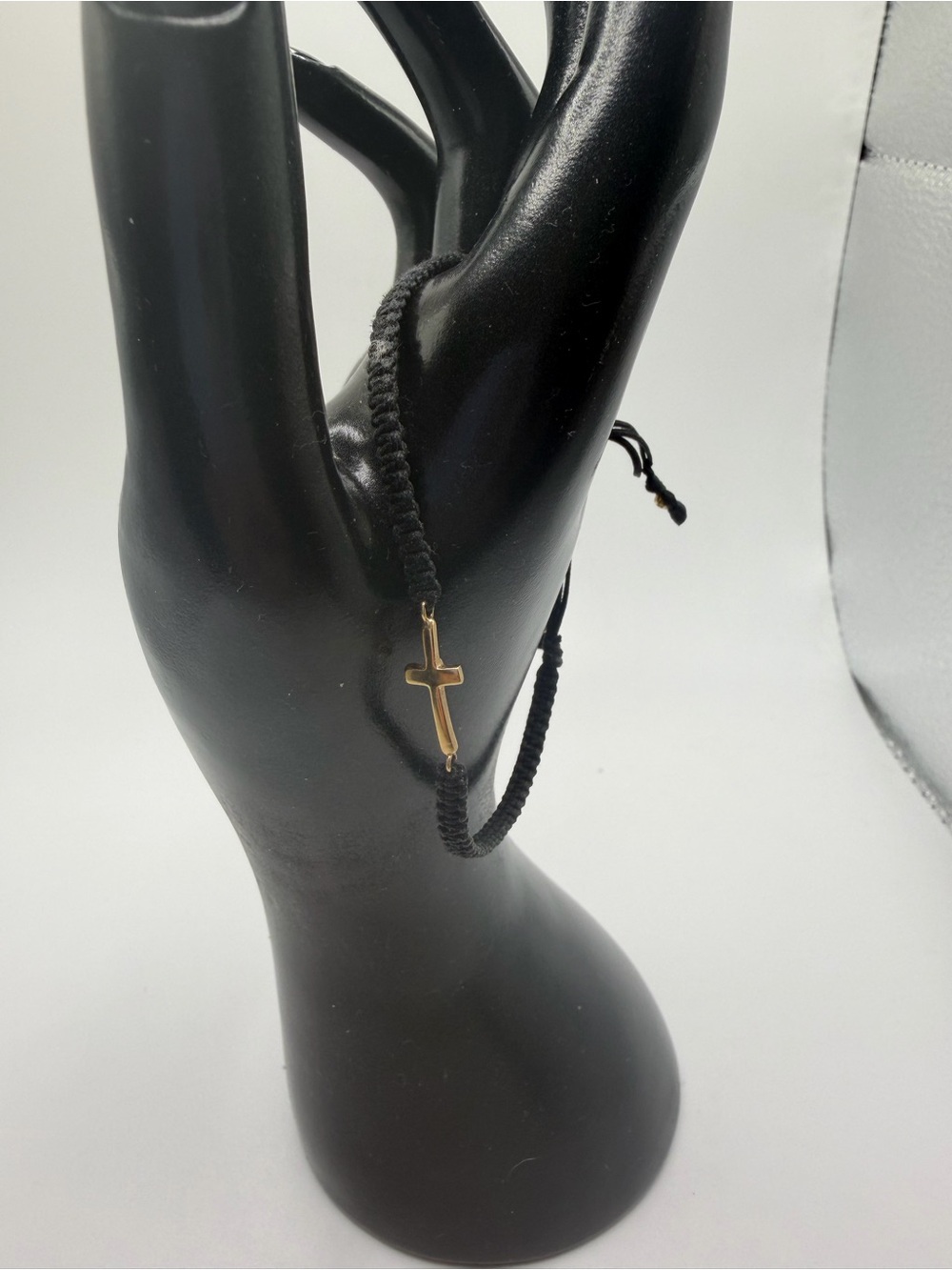 Black string Bracelet with 10k yellow Gold Cross Charm